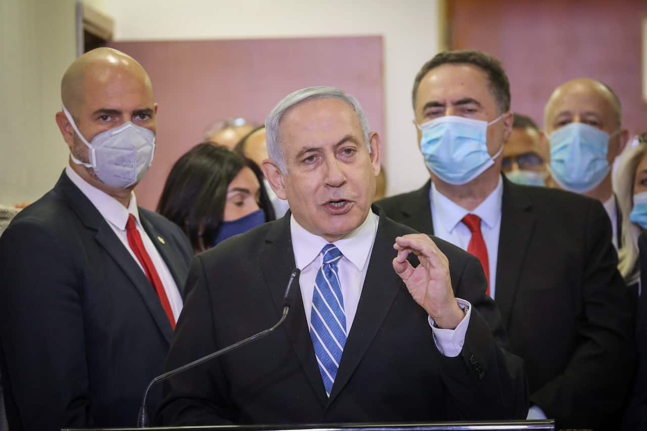 Israeli Prime Minister Benjamin Netanyahu delivers a statement before entering the district court room where he is facing a trial for alleged corruption