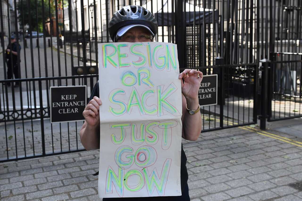 A woman protests outside 10 Downing Street, London, prior to Dominic Cummings giving his statement over allegations he breached lockdown restrictions.