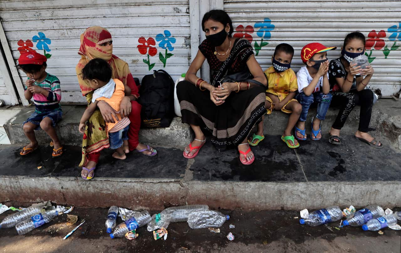 Migrant people gather for transport to train station for their onward journey to Uttar Pradesh and Bihar at Dharavi slum in Mumbai, India.