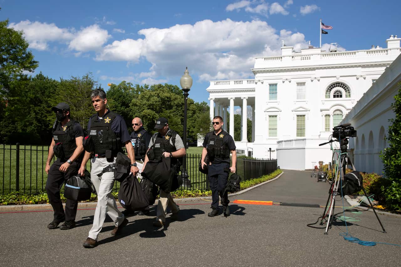 Members of the US Secret Service gather at the White House on Saturday as protests flared over George Floyd's death.