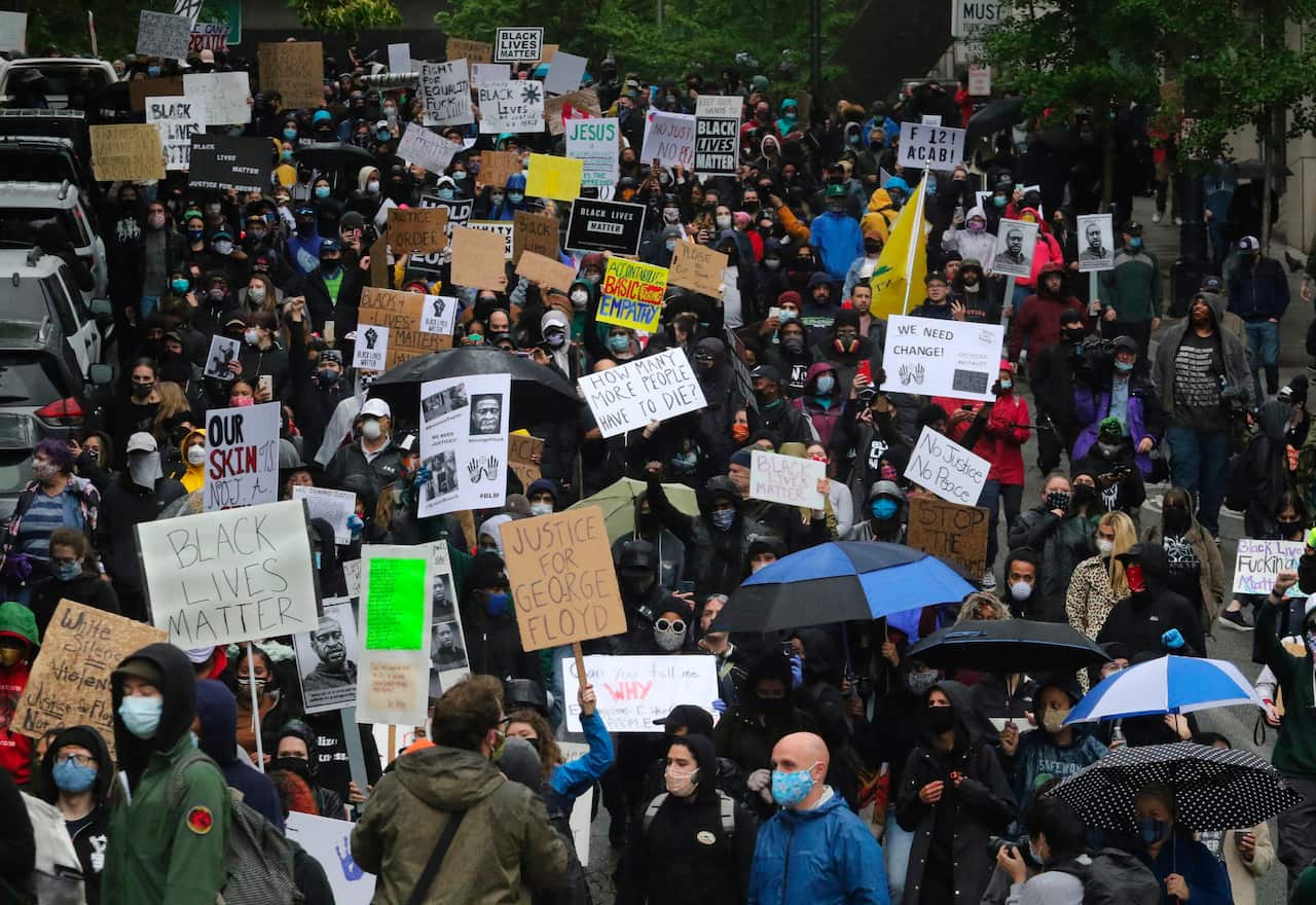 Hundreds of peaceful protesters attending the Seattle demonstration on 30 May.