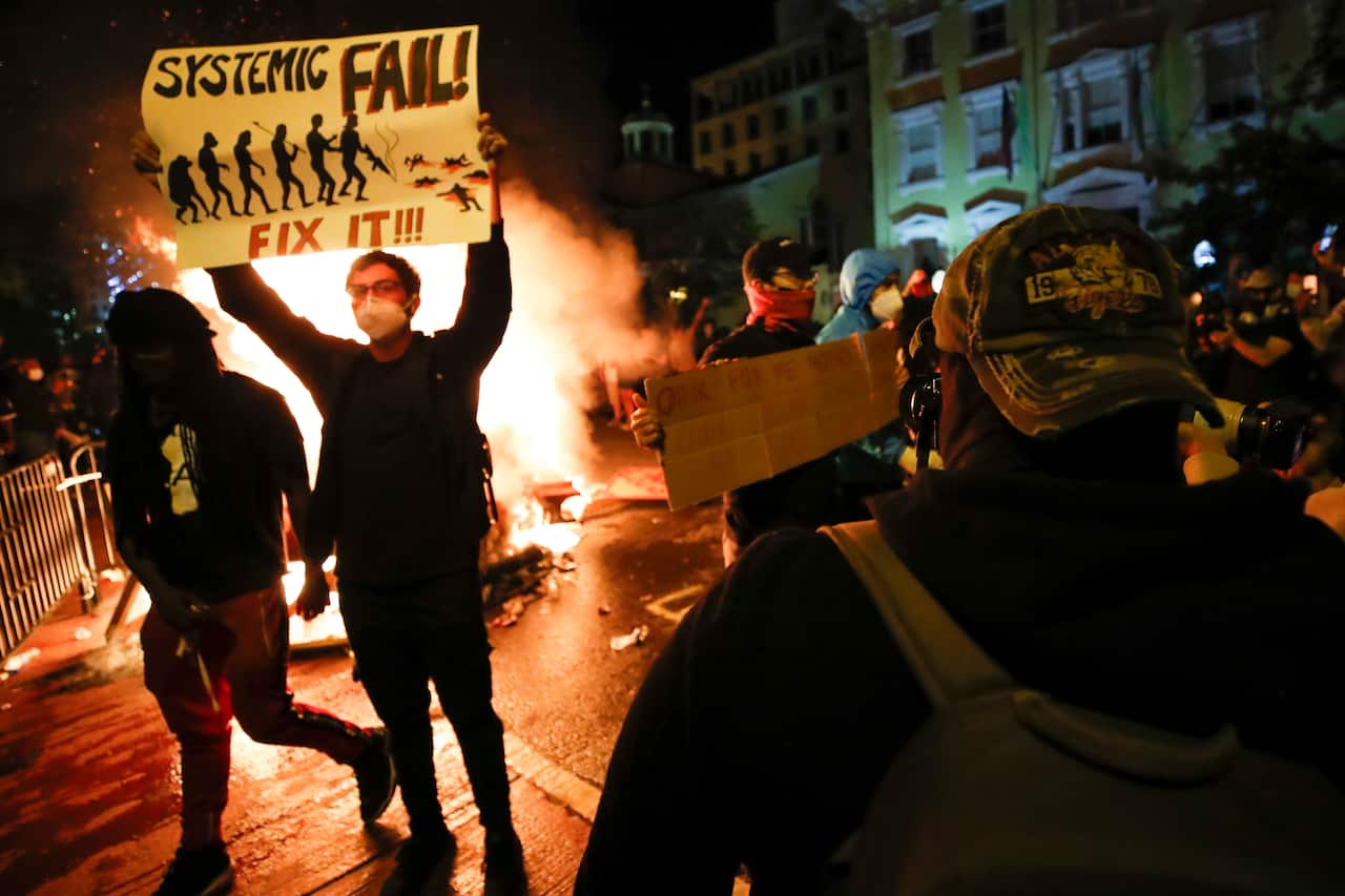 Demonstrators protest the death of George Floyd, 31 May, 2020, near the White House in Washington.