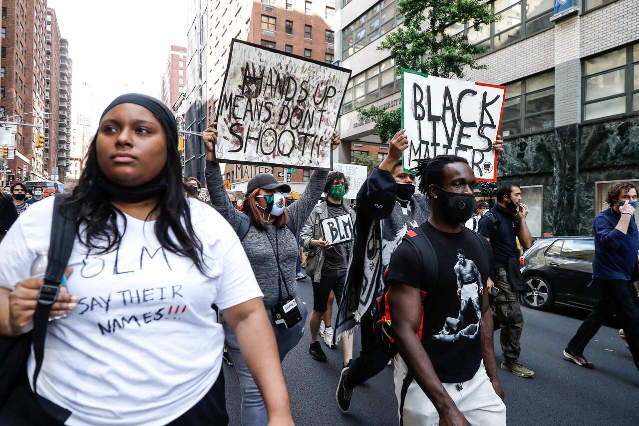 Protesters hold placards as they take part during a demonstration in response to the death of a Minneapolis man George Floyd.
