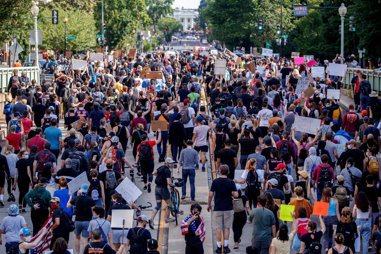 Protesters march towards the White House in Washington DC.