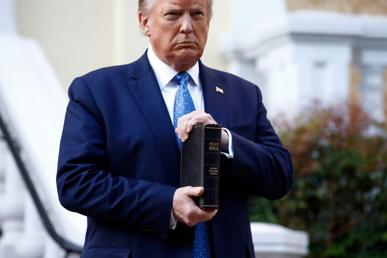 President Donald Trump holds a bible outside a church damaged by protesters earlier this week. 