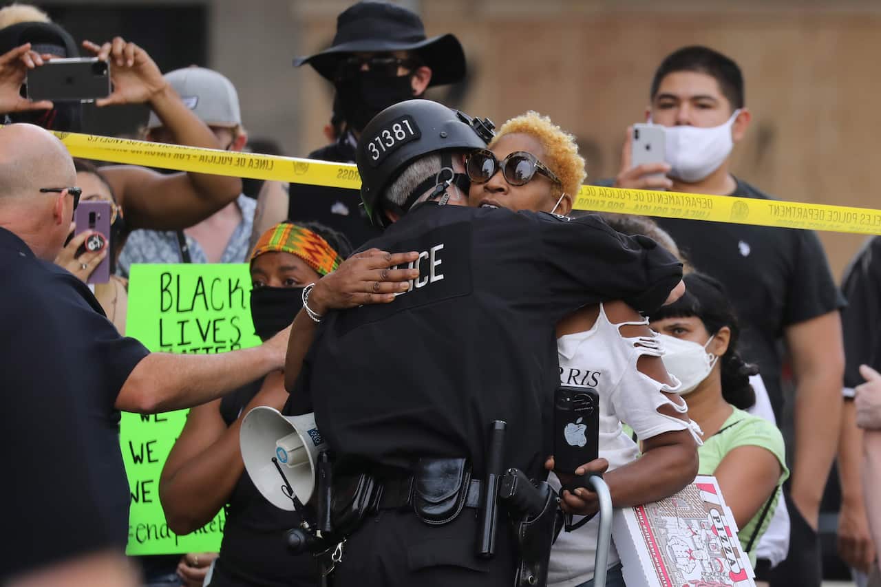 A protester hugs an LAPD officer in Hollywood, Los Angeles, during a George Floyd demonstration.