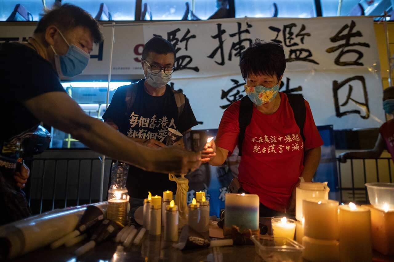 Pro-democracy activists light up candles on the eve of the Beijing Tiananmen Massacre anniversary in Hong Kong.