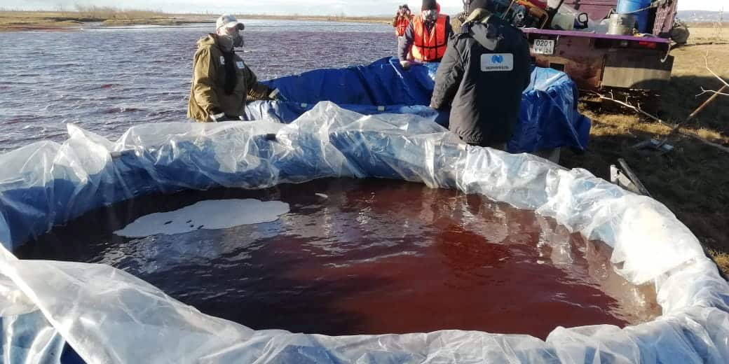 Rescuers working at the site of oil products spill into the Ambarnaya river outside of Norilsk, Russia.
