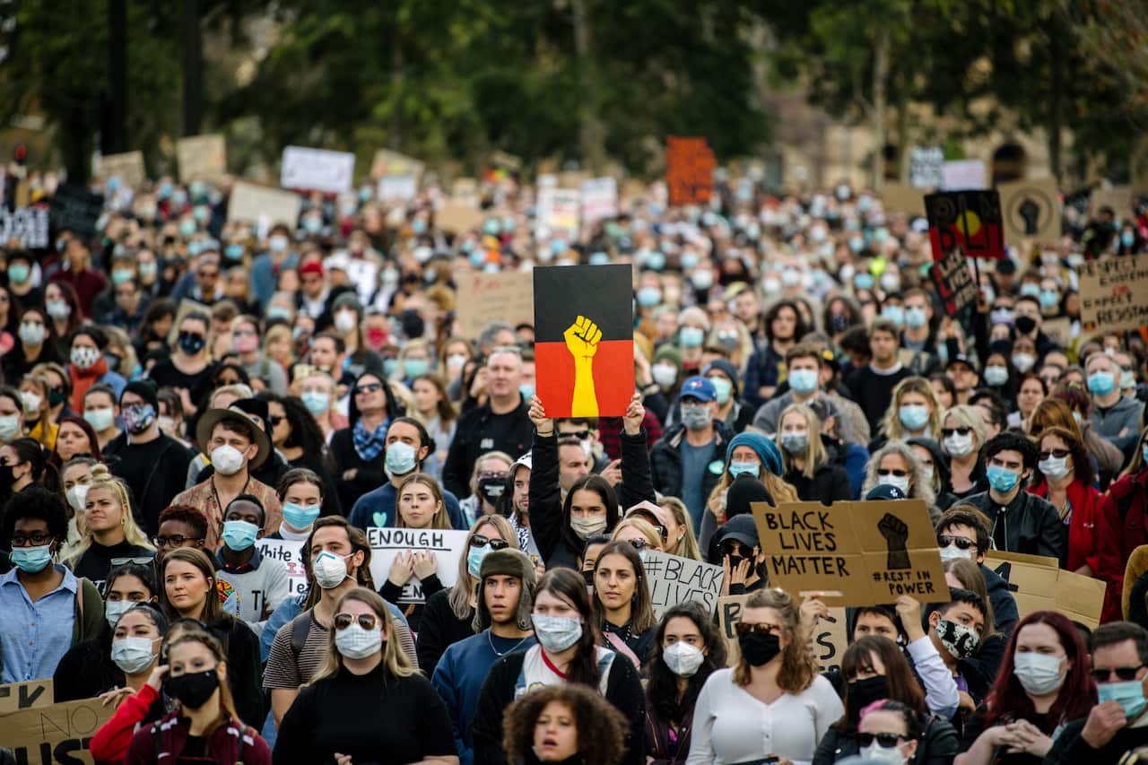 Protesters participate in a Black Lives Matter rally in Adelaide on Saturday, June, 6, 2020. A protest against the deaths of Aboriginal people in custody and solidarity with the US protests for George Floyd. (AAP Image/Morgan Sette) NO ARCHIVING
