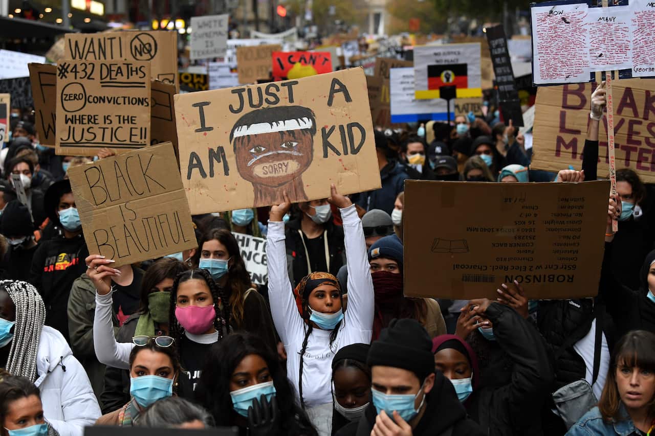 Protesters are seen a Black Lives Matter rally in Melbourne.