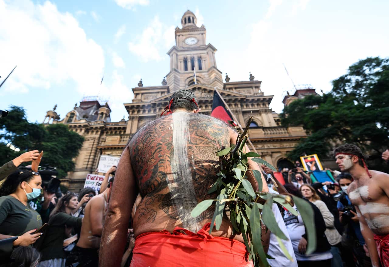Aboriginal Elders participating in a traditional smoke ceremony in front of Sydney Town Hall at the Black Lives Matter rally in Sydney. 