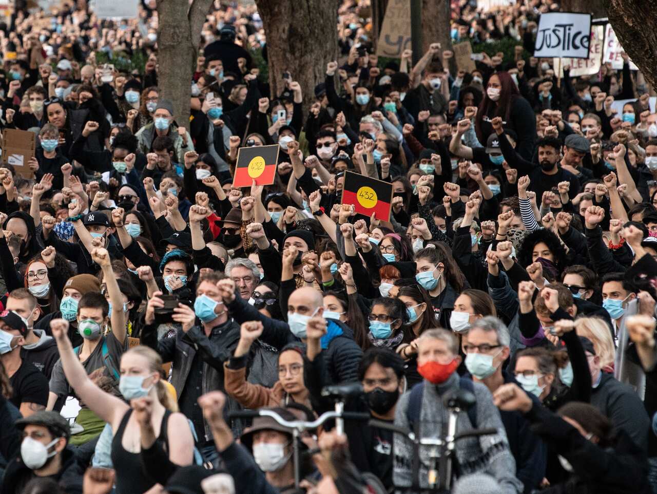 Thousands of protesters kneel at a Black Lives Matter rally in Sydney on Saturday.