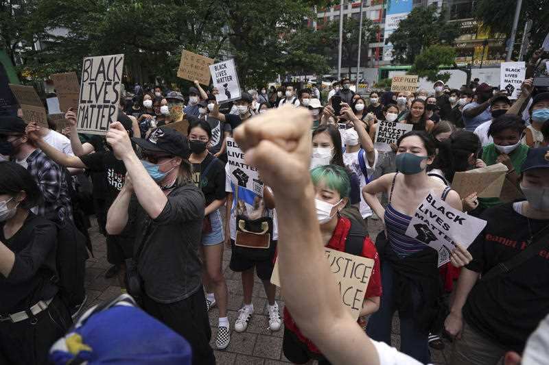 People gather to protest during a solidarity rally for the death of George Floyd Saturday, June 6, 2020, in Tokyo