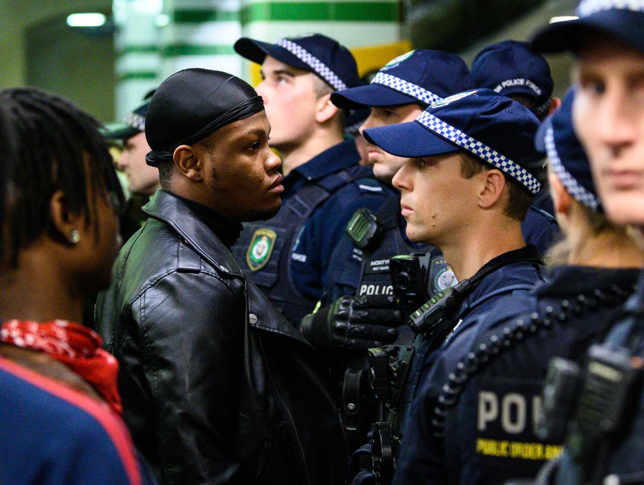 A protestor faces a police officer inside Central Station after a Black Lives Matter rally in Sydney.