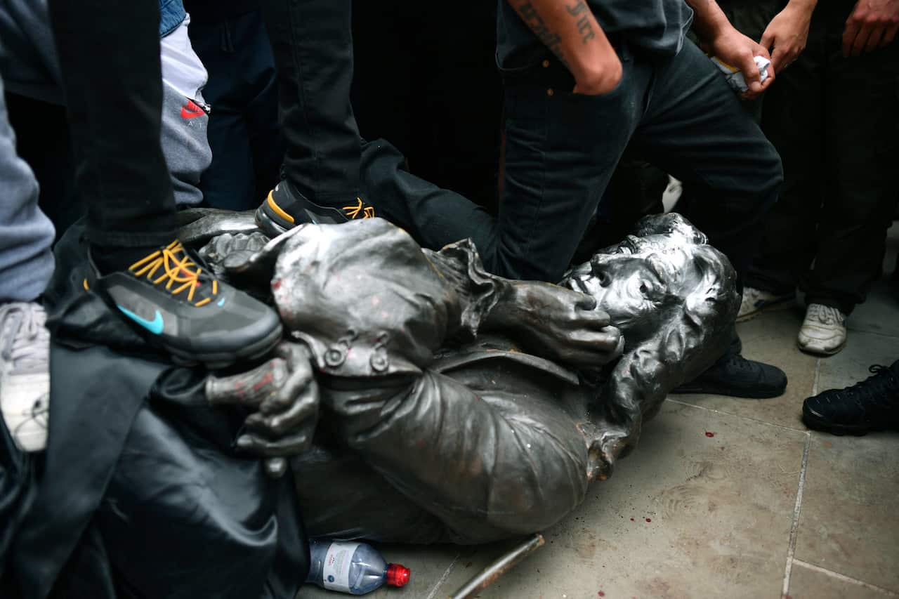 Protesters pull down a statue of Edward Colston during a Black Lives Matter protest rally in College Green, Bristol.