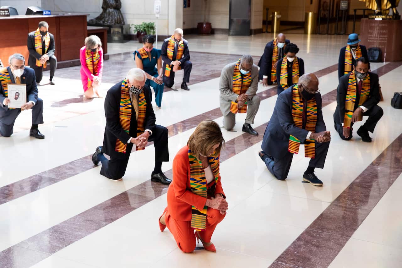 US Speaker of the House Nancy Pelosi and Democratic politicians kneel.