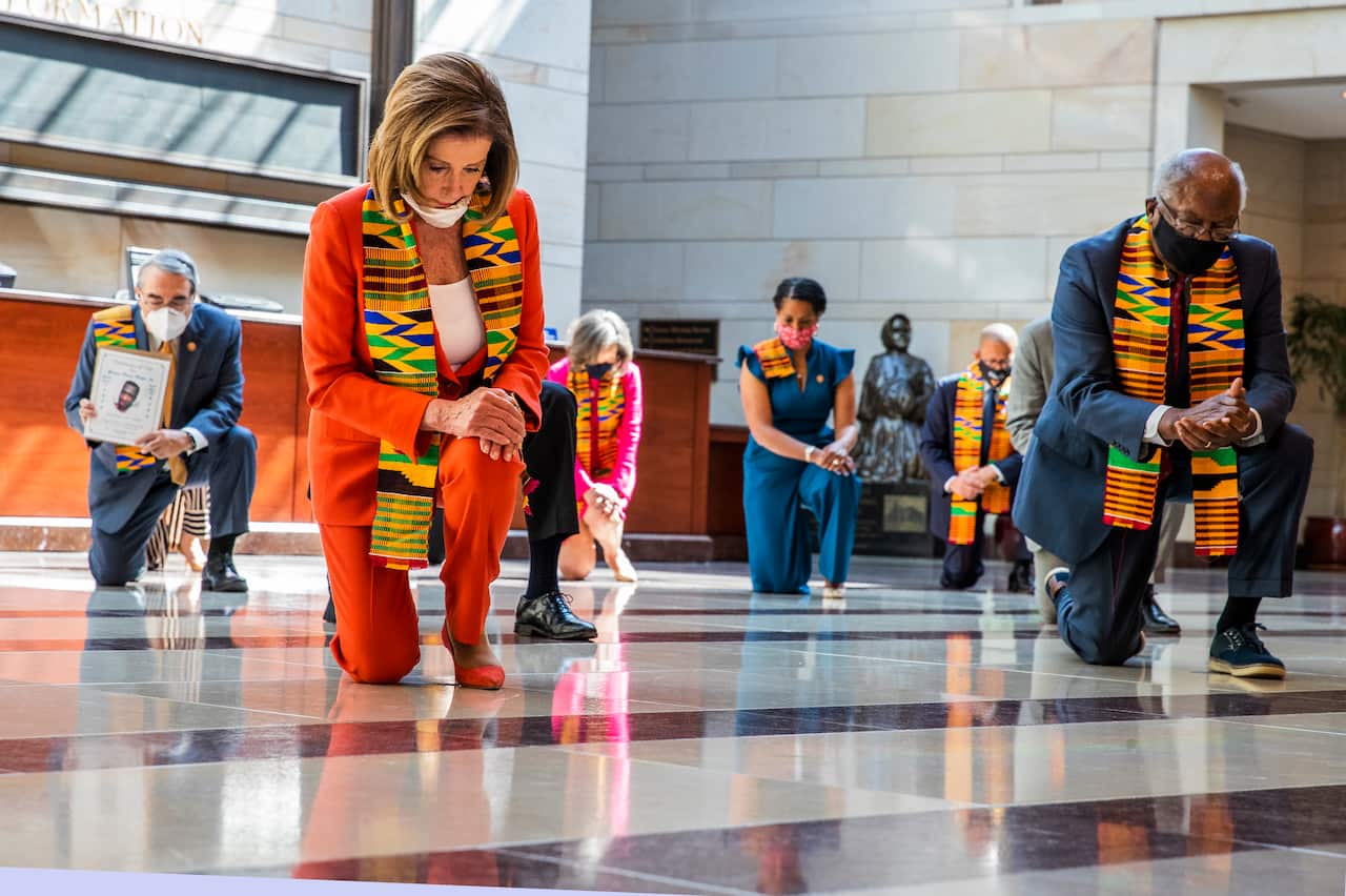 House Speaker Nancy Pelosi and other members of Congress gather at the Emancipation Hall, kneel and observe a moment of silence to honour George Floyd.