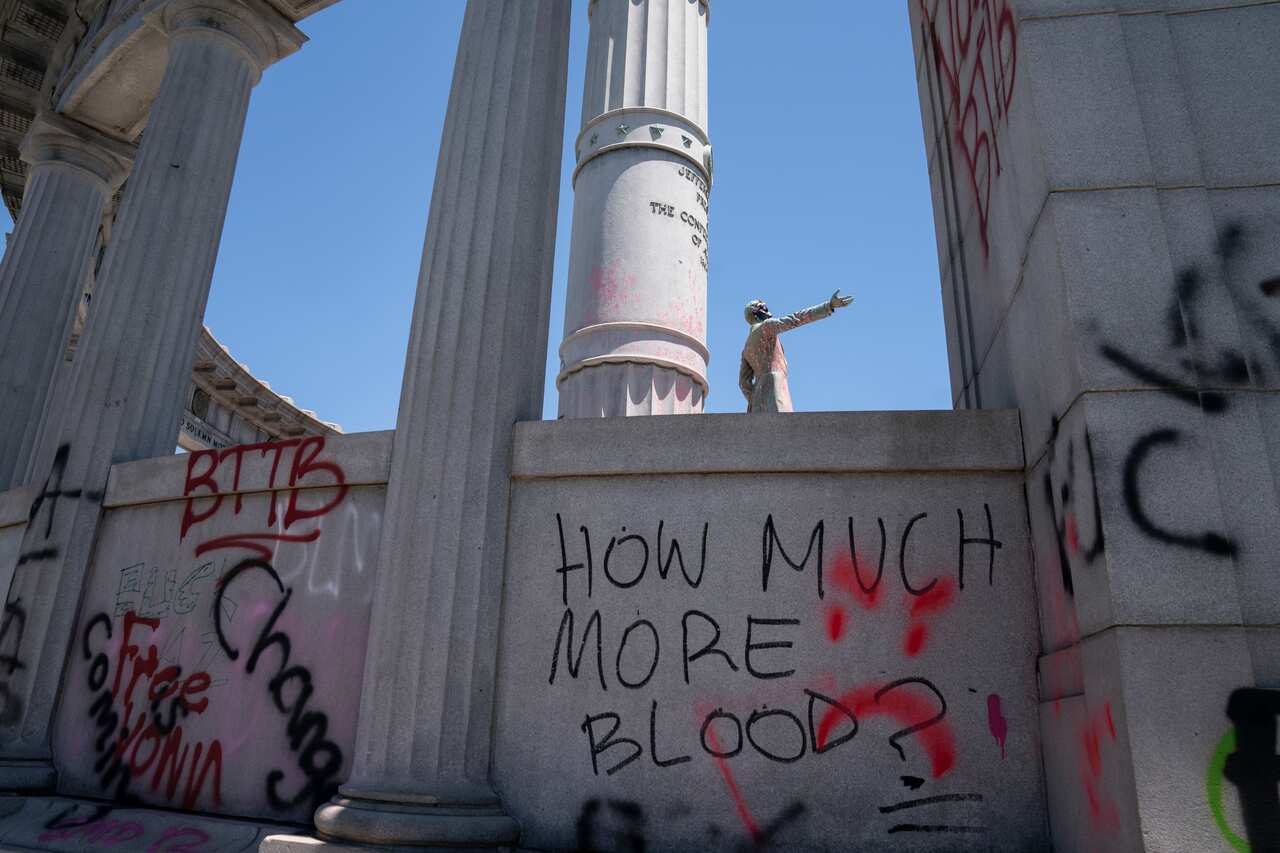 Paint and protest graffiti covers the Jefferson Davis Memorial in Richmond, Virginia.