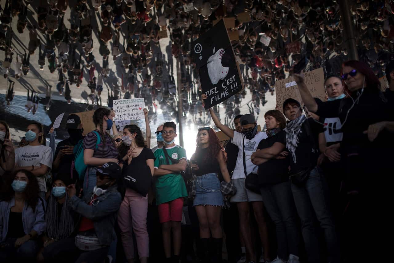 A protester holds a sign that reads "kill, it is being filmed" in Marseille, southern France.