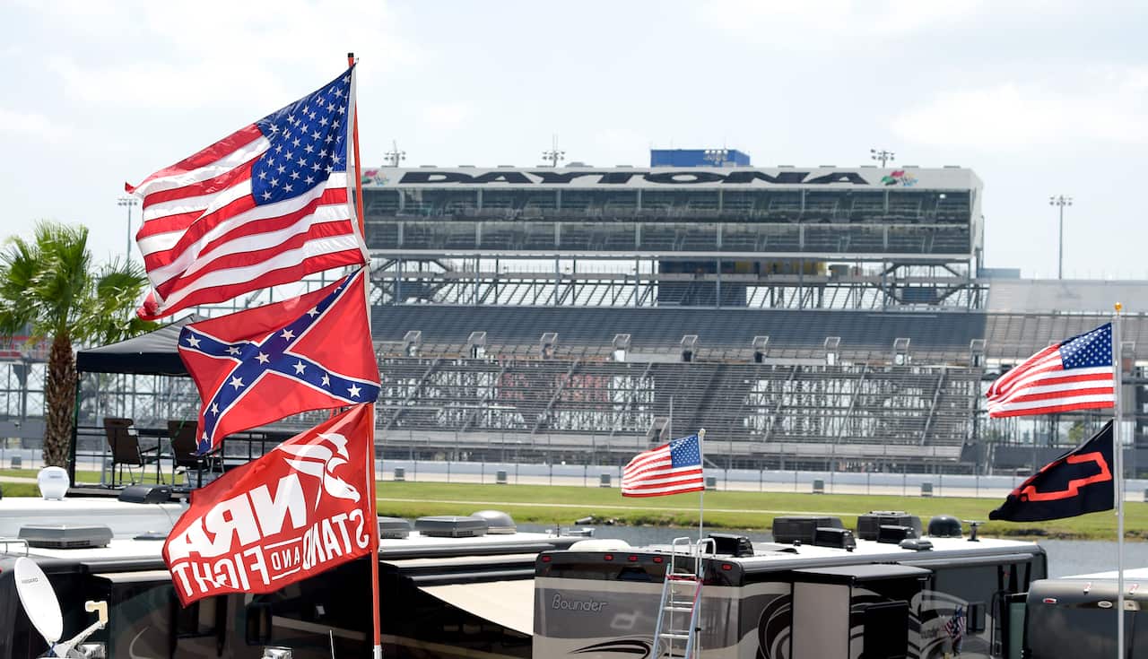 Confederate and American flags fly on top of motor homes at Daytona International Speedway in Daytona Beach, Florida.
