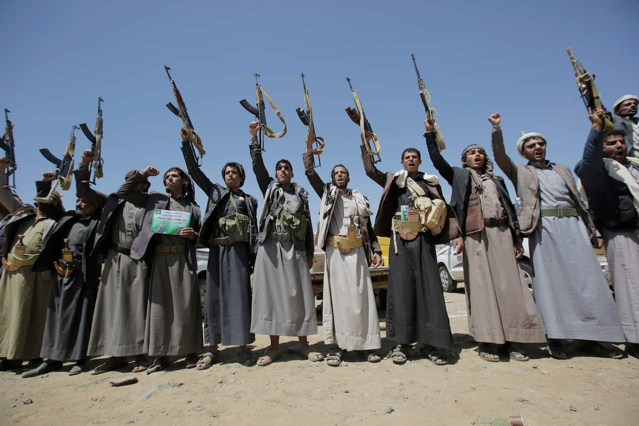 Shiite Houthi tribesmen hold their weapons as they chant slogans during a tribal gathering showing support for the Houthi movement, in Sanaa, Yemen, 2019.