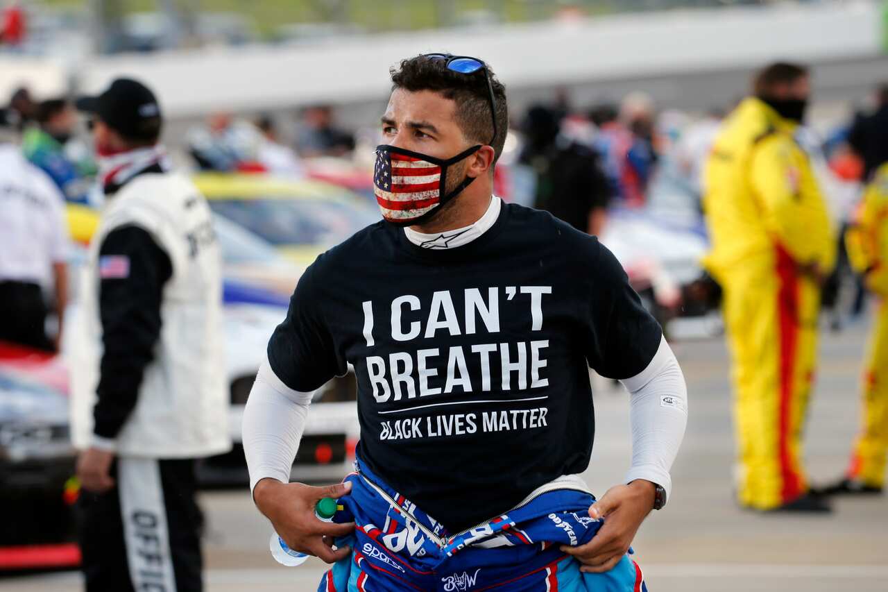 Driver Bubba Wallace wears a Black Lives Matter shirt as he prepares for a NASCAR Cup Series auto race Wednesday, June 10, 2020, in Martinsville, Va. (AP Photo/Steve Helber)