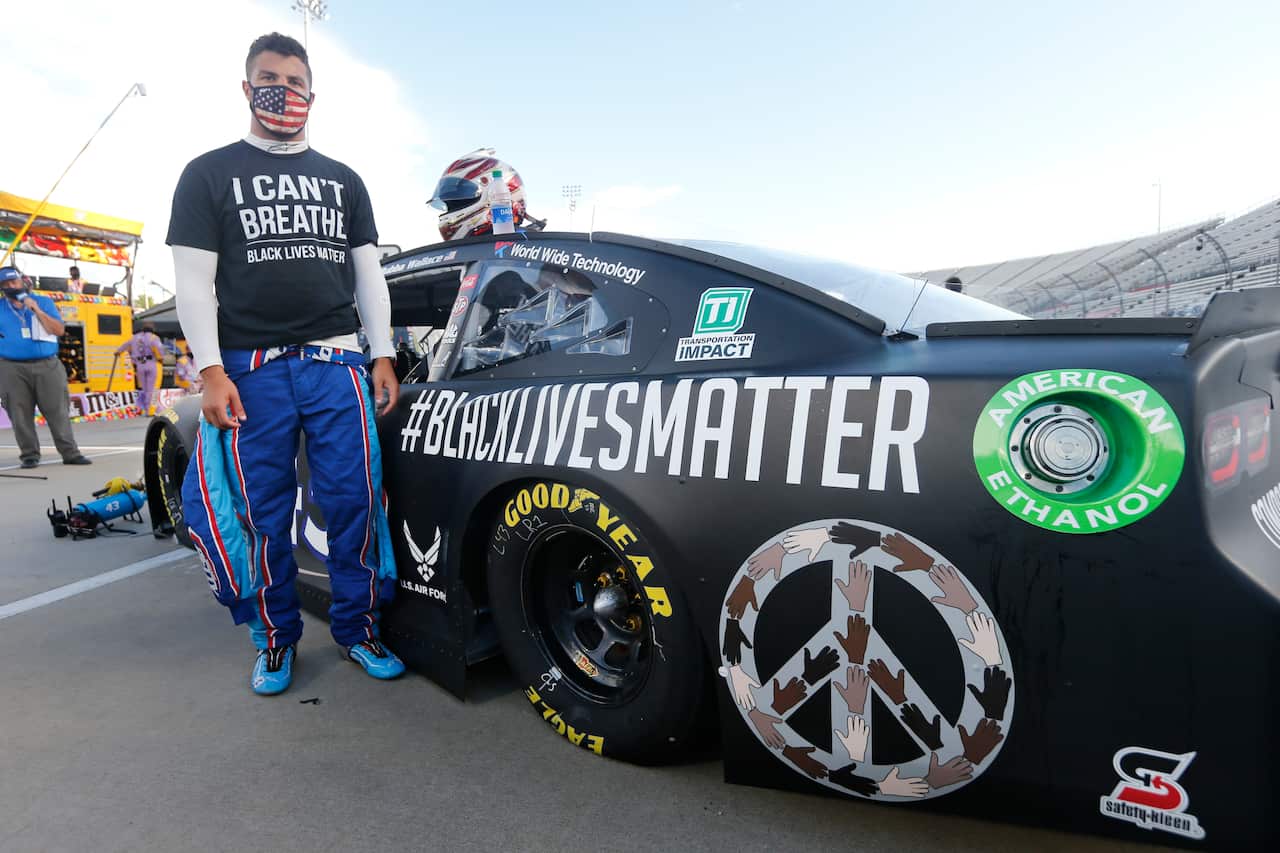 Driver Bubba Wallace waits for the start of a NASCAR Cup Series auto race Wednesday, June 10, 2020, in Martinsville, Va. (AP Photo/Steve Helber)