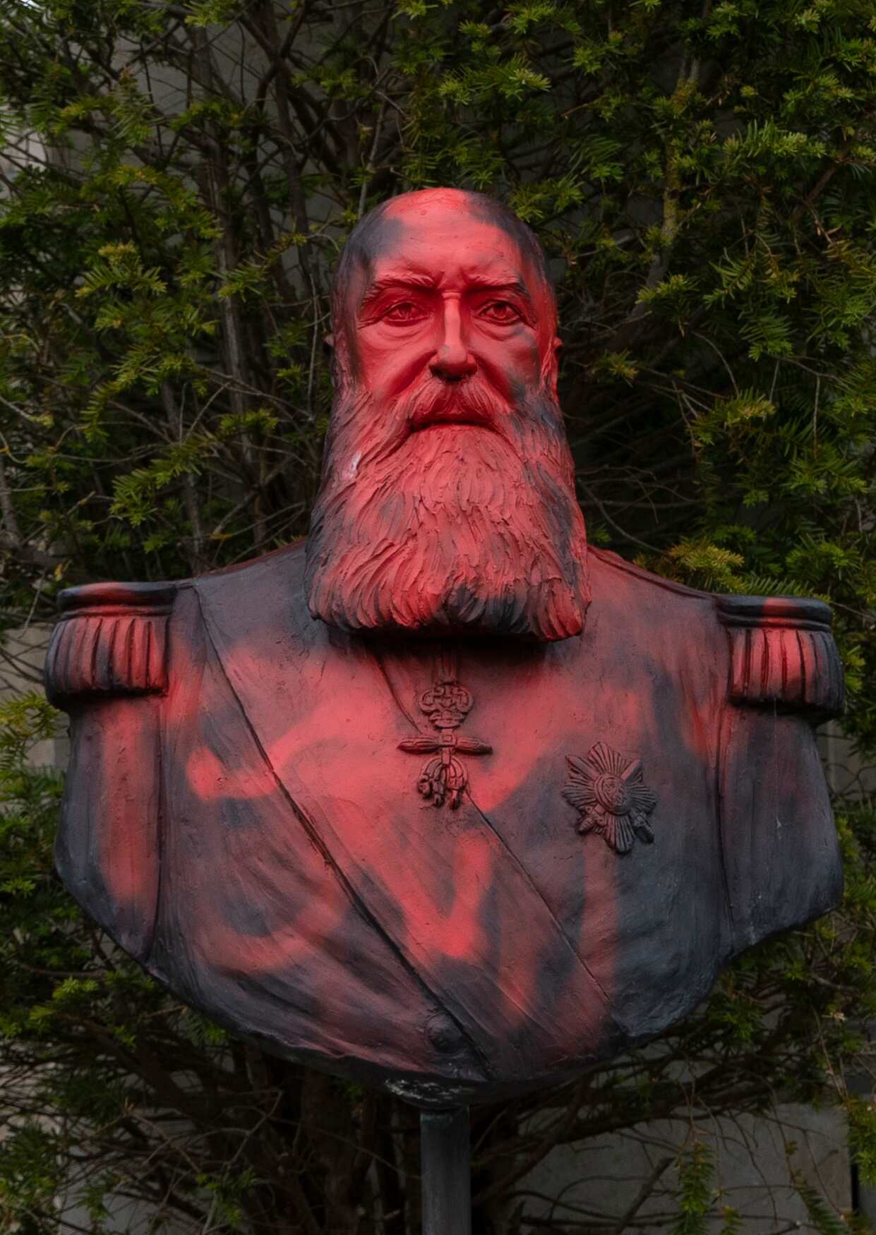A bust of Belgium's King Leopold II is smeared with red paint and graffiti in Tervuren, Belgium on Tuesday, June 9, 2020. 