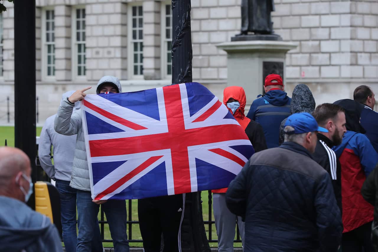 People outside City Hall in Belfast in Northern Ireland to the protect war memorials in its grounds..
