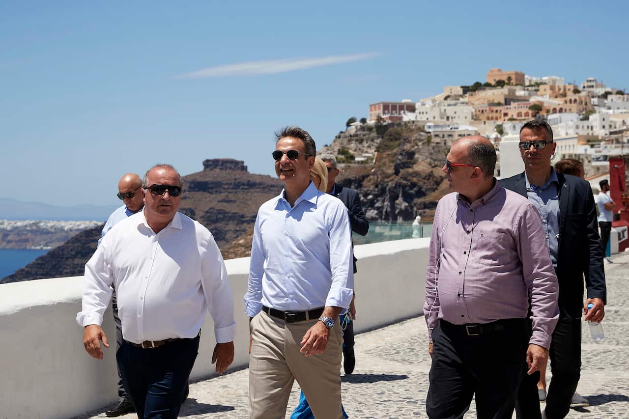 Prime Minister Kyriakos Mitsotakis walking in Fira cit, during his visit in Santorini Island.