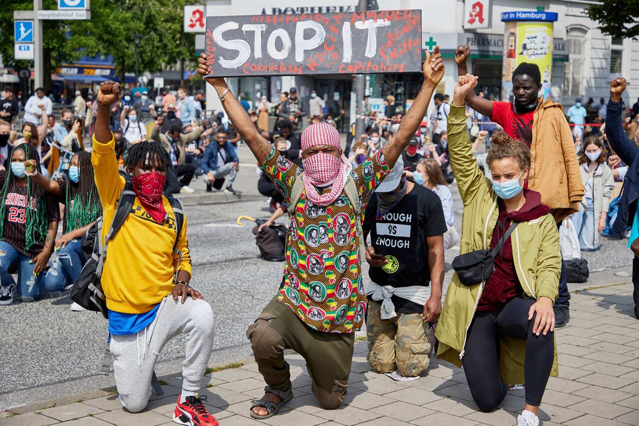 People demonstrate against racism during a protest at Steintorplatz in Hamburg, Germany.