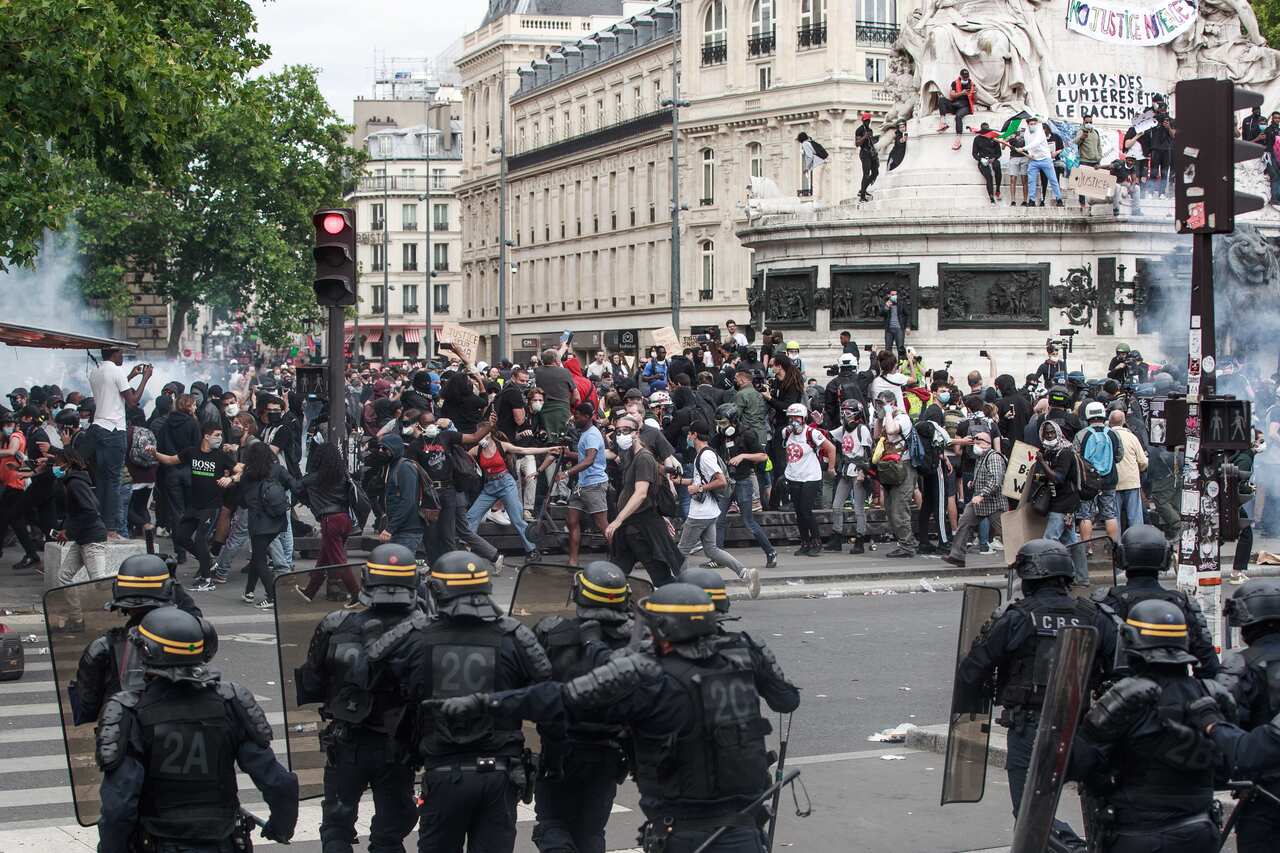 Protesters clash with riot police during a demonstration against police brutality and racism in Paris, France.