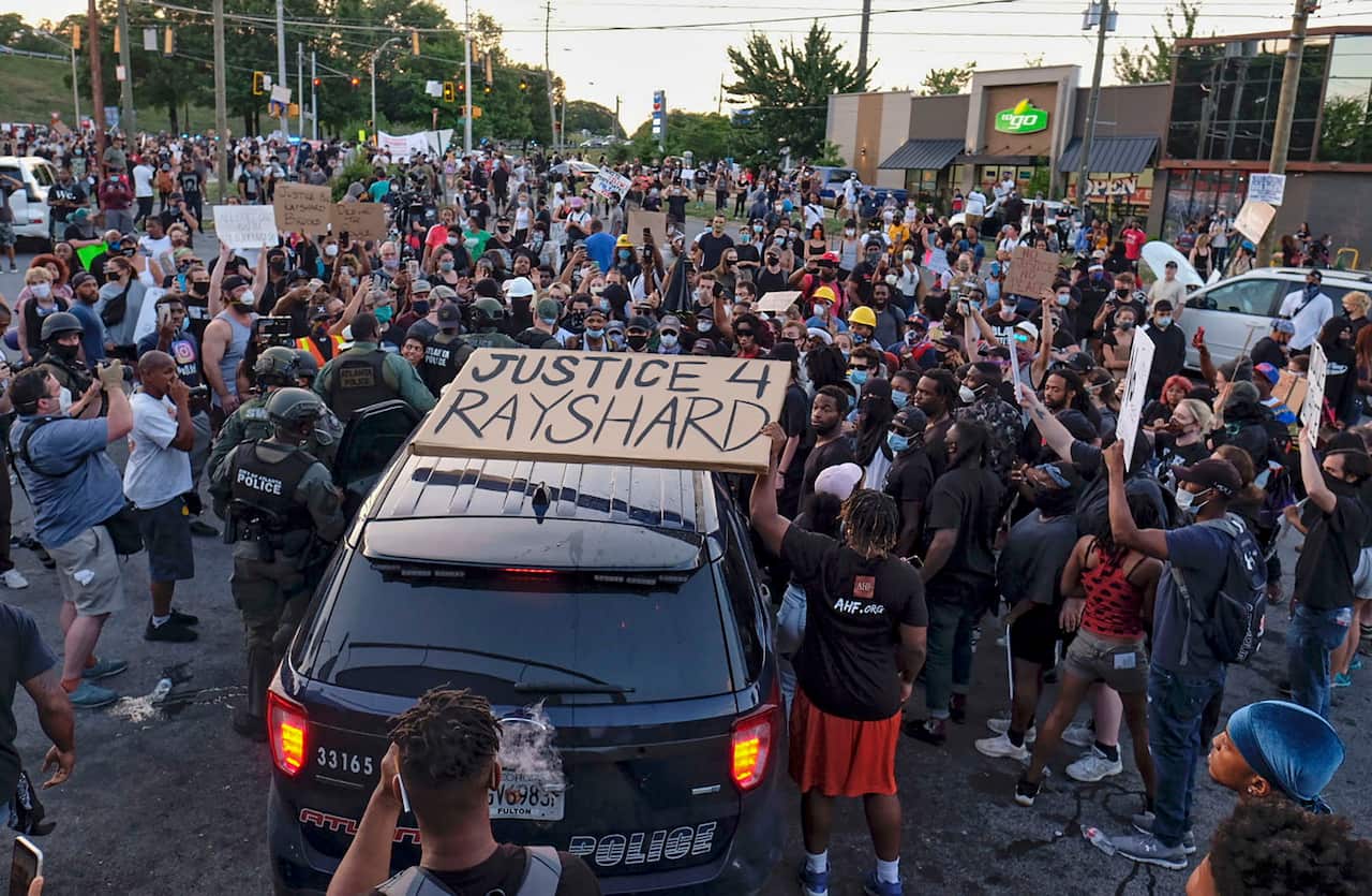 Protesters gather outside the Wendy's restaurant. 