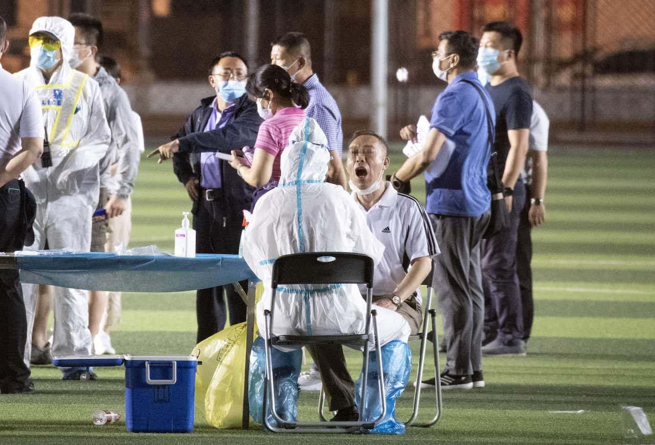 Hundreds of people who had been at the Xinfadi market gather at Xuanwu Stadium to take the COVID-19 test in Beijing,China on 14th June, 2020.