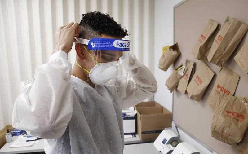 A worker at a St. Vincent de Paul medical clinic, Monday, June 15, 2020, in Phoenix. 