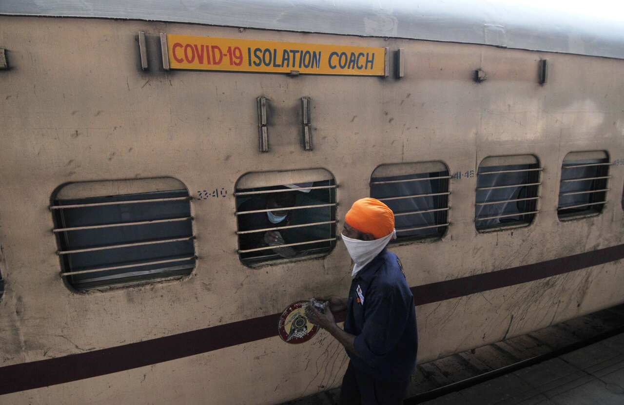An Indian worker prepares a railway coach converted into a coronavirus care centre parked at Anand Vihar Railway station in New Delhi, India, 16 June 2020. 
