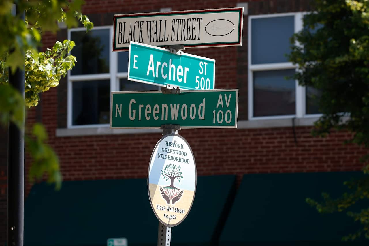 A sign marks the intersection of Greenwood Avenue and Archer Street, the former home of Black Wall Street, in Tulsa, Oklahoma.