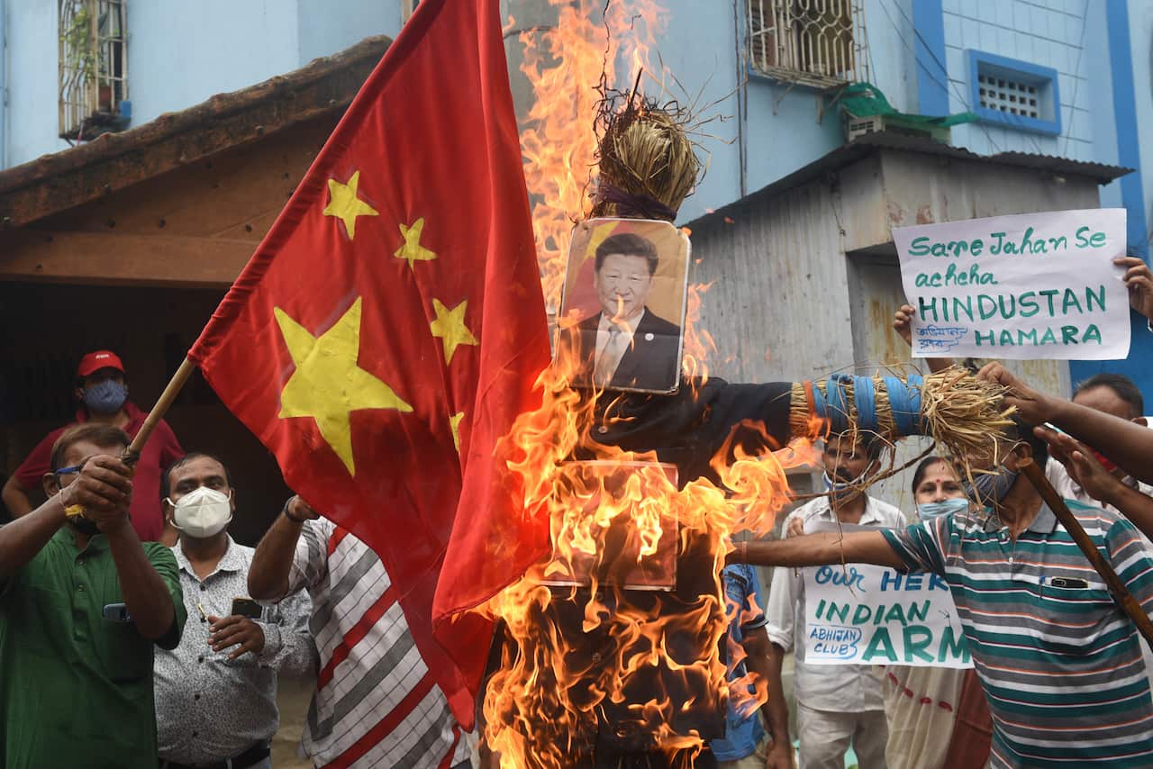 Members of Abhijan Club burn an effigy of Chinese President Xi Jinping and a Chinese flag during a protest against the deaths of Indian army personnel.