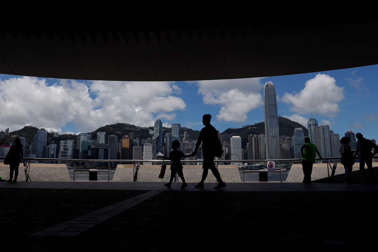 People walk at the waterfront of the Victoria Harbor of Hong Kong.
