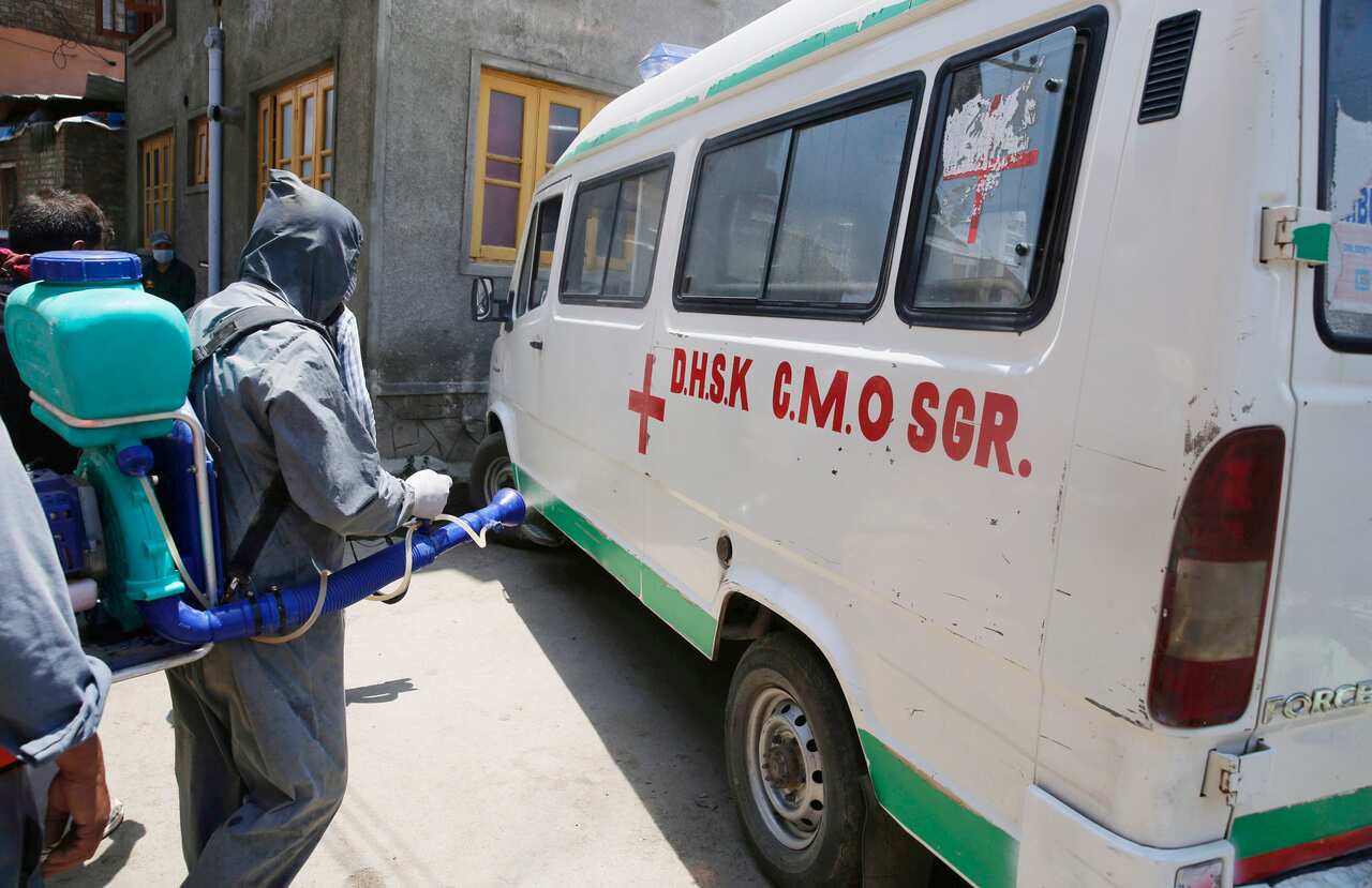 A government  worker spraying disinfectant to an ambulance in Srinagar, the summer capital of Indian Kashmir, India, 20 June 2020. 