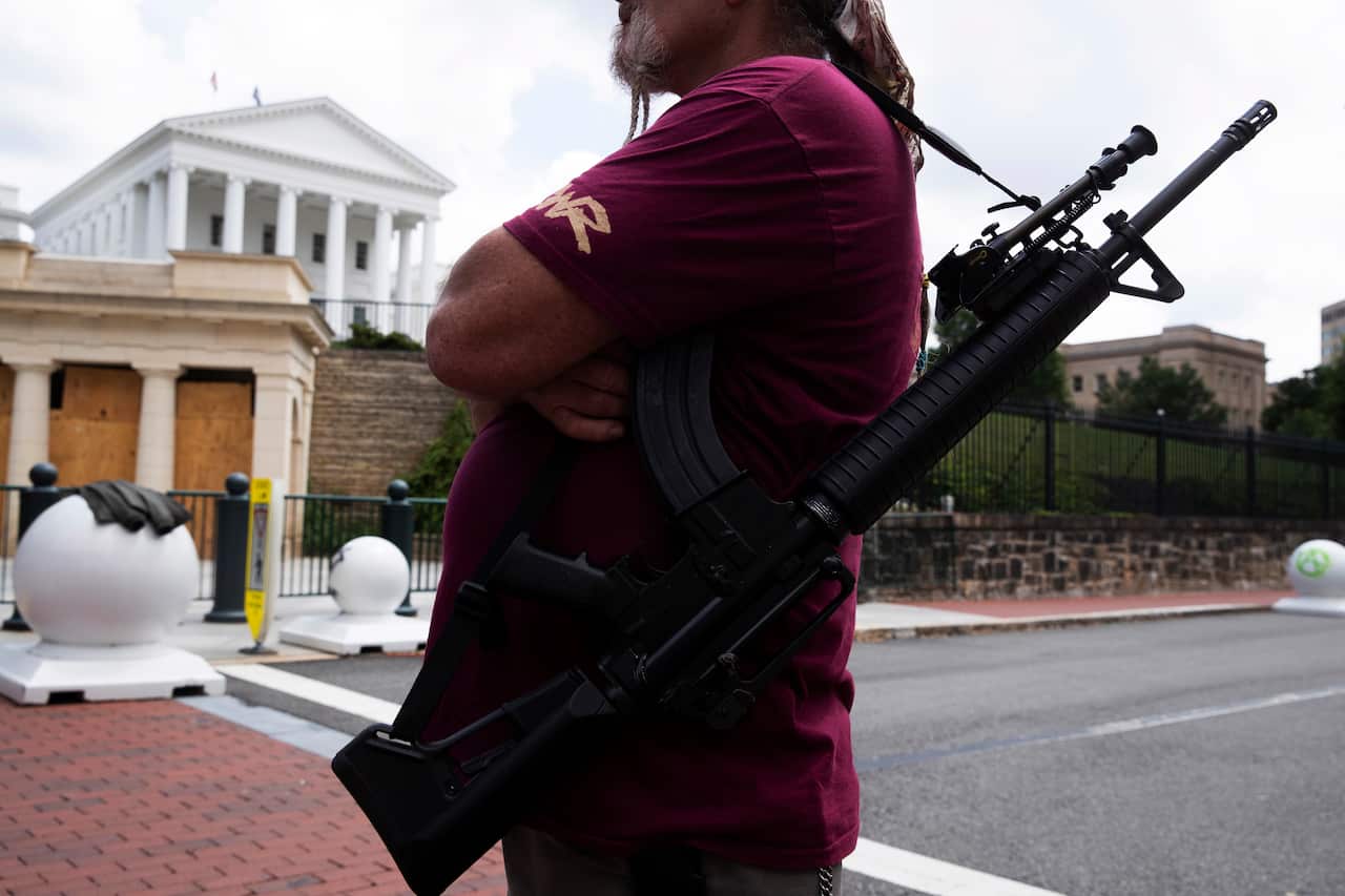 A member of the second amendment advocacy group, 'The Right to Bear Arms Virginia', holds a semi-automatic firearm during a rally in Richmond, Virginia, USA.