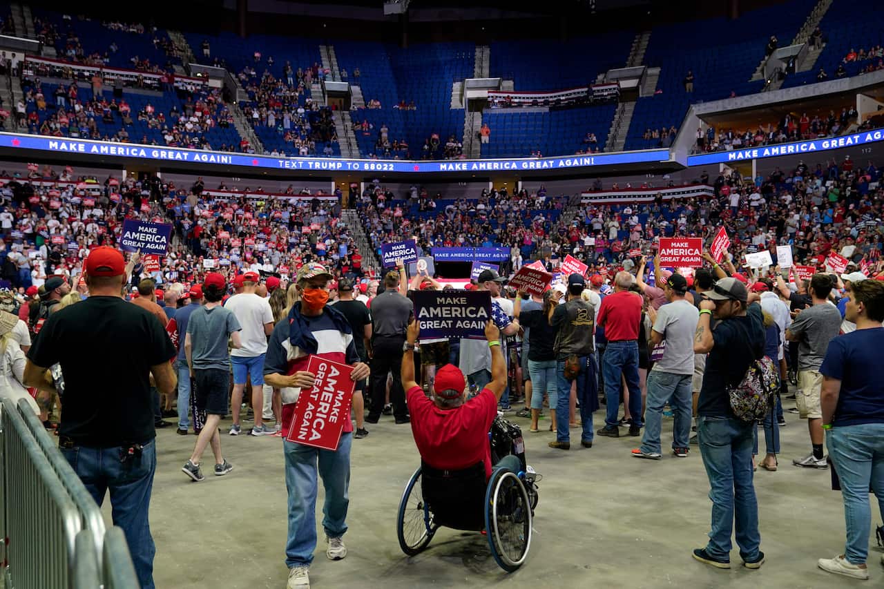President Donald Trump supporters listen to Trump speak during a campaign rally at the BOK Center in Tulsa, Oklahoma.