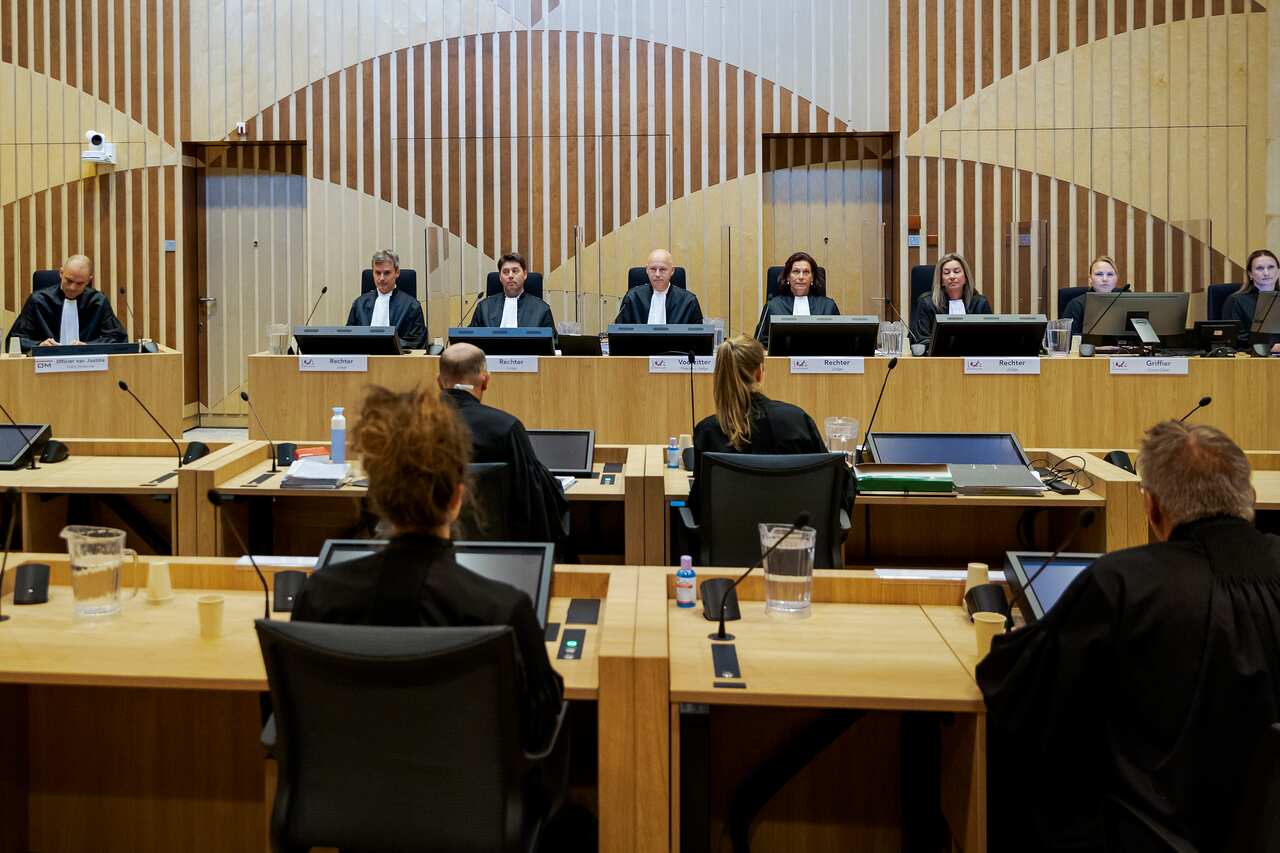 Judge Hendrik Steenhuis, rear, fourth from left, opens the court as the trial resumed for three Russians and a Ukrainian charged with shooting down of MH17.