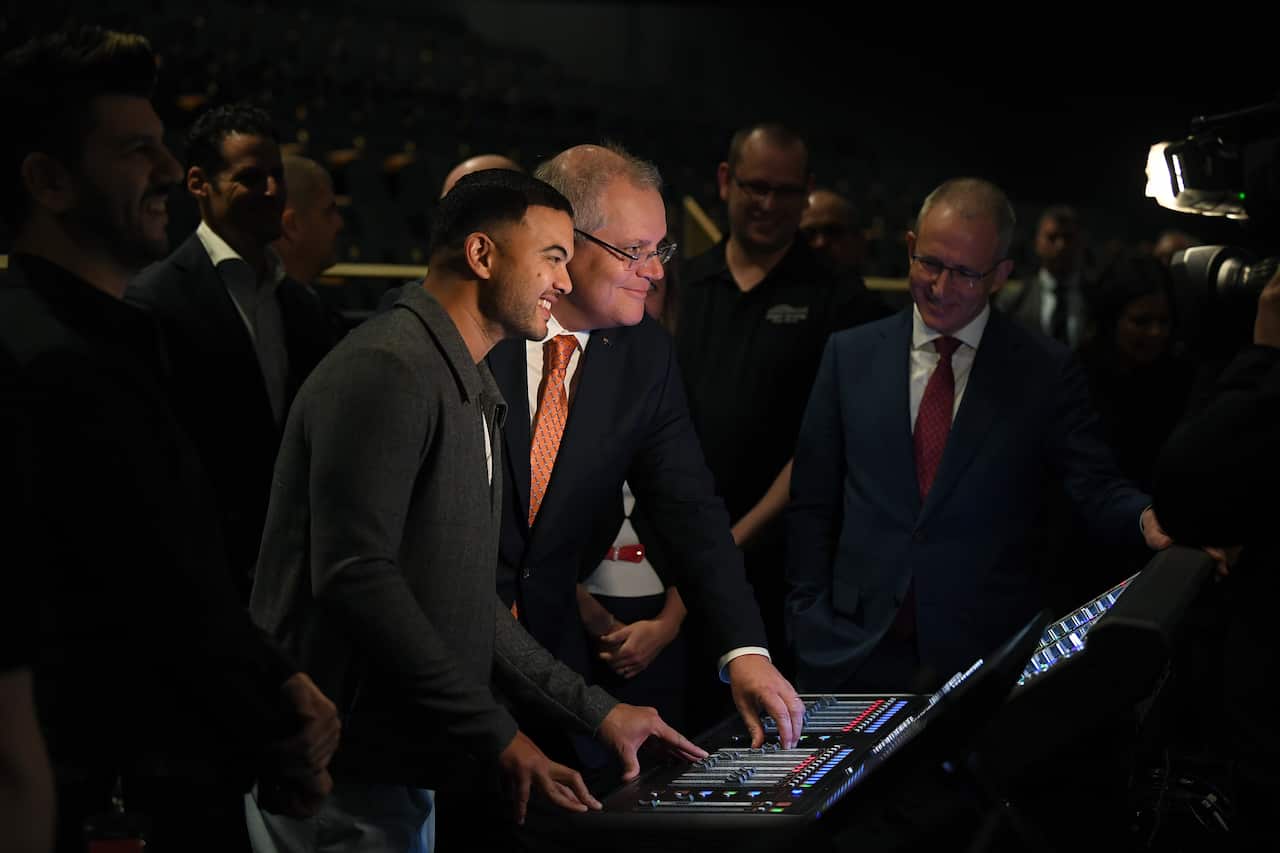 Australian Prime Minister Scott Morrison and singer Guy Sebastian view a sound desk in the Sydney Coliseum Theatre during a tour of West HQ at Rooty Hill in Sydney, Thursday, June 25, 2020. (AAP Image/Joel Carrett) NO ARCHIVING
