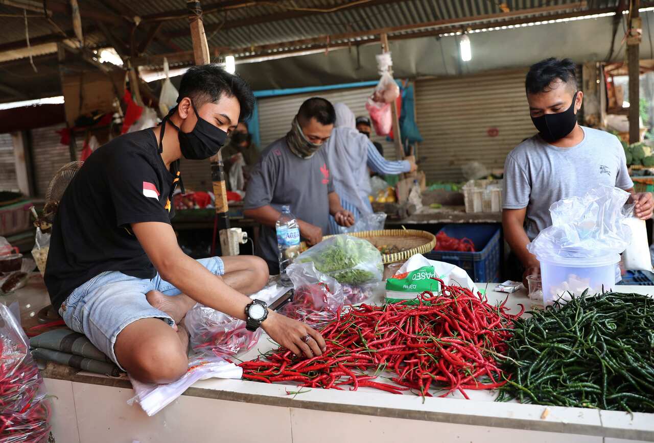Vendors wearing protective masks in Jakarta.