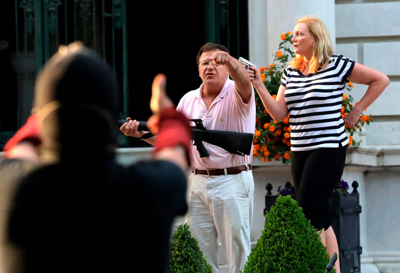 Armed homeowners standing in front their house along Portland Place confront protesters