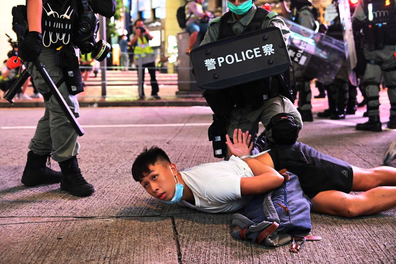 Police officers detain protesters during a rally against a new national security law on July 1 in Hong Kong.