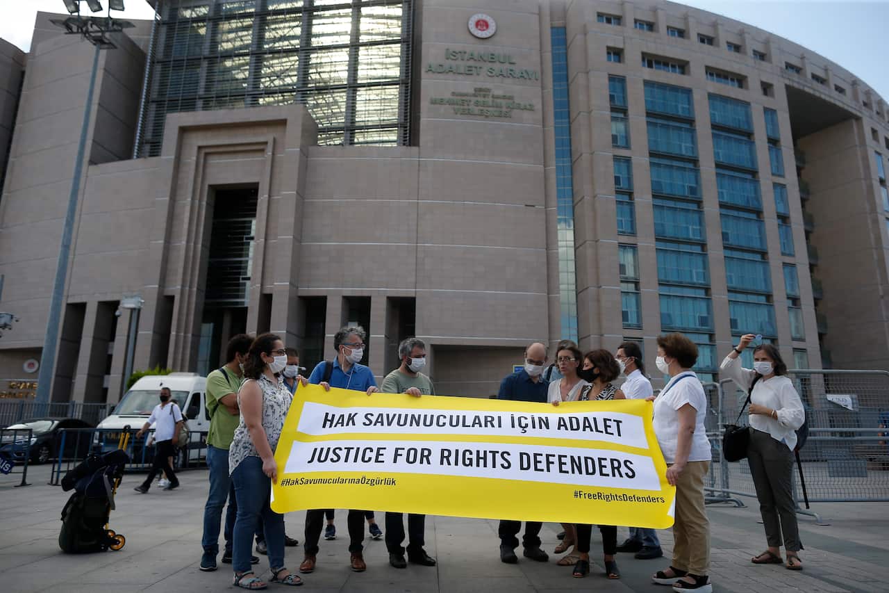 Demonstrators from Amnesty International stage a protest outside the Istanbul court on 3 July. 