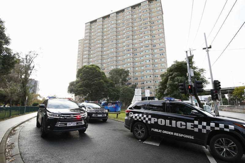 Police patrols are seen outside public housing towers on Racecourse Road in Flemington, Melbourne, Sunday, July 5, 2020