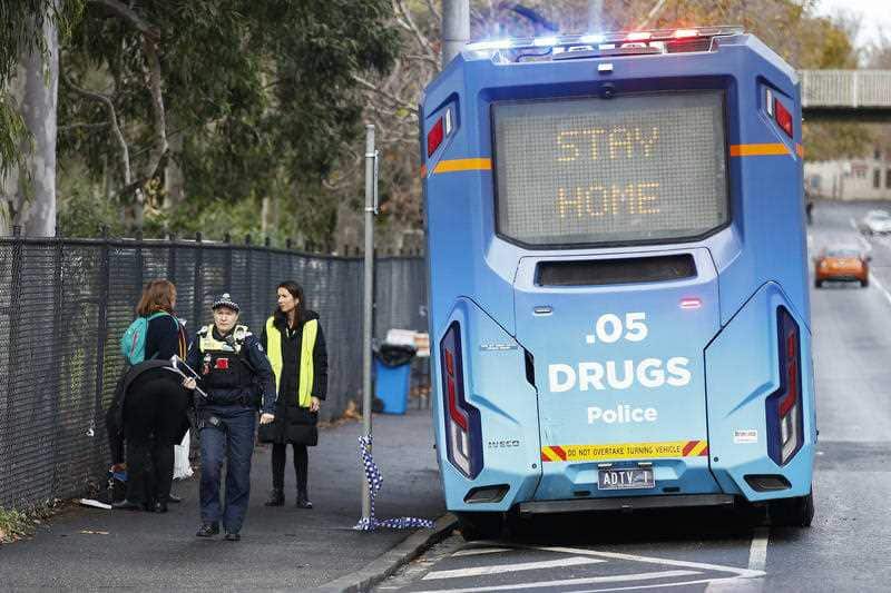 Police patrols are seen outside public housing towers in North Melbourne, Sunday, July 5, 2020.